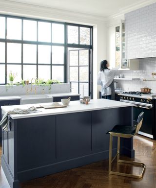 Kitchen painted in Benjamin Moore's Hale Navy paired with white walls and wooden accents
