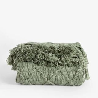 A green cable knit chunky throw