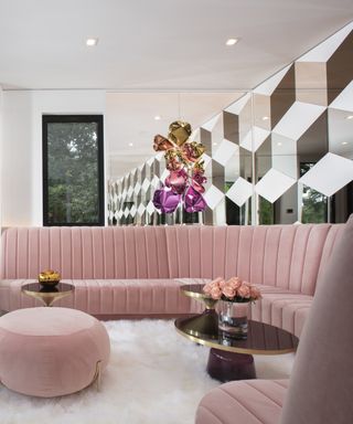 Florida style living room with pink sofas and white rug