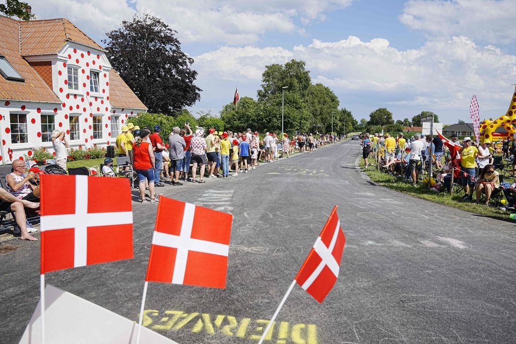 Cycling fans standing in front of a reddotted house cheer along the route in Diernaes Strand near Haderslev during the 3rd stage of the 109th edition of the Tour de France cycling race 182 km between Vejle and Sonderborg in Denmark on July 3 2022 Denmark OUT Photo by Bo Amstrup Ritzau Scanpix AFP Denmark OUT Photo by BO AMSTRUPRitzau ScanpixAFP via Getty Images