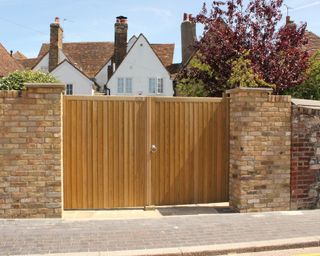 wooden gate from Jacksons Fencing with brick wall
