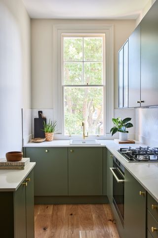 A kitchen in muted sage green