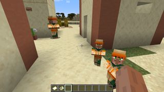 Minecraft villager - Two baby villagers stand outside a house in a desert village.