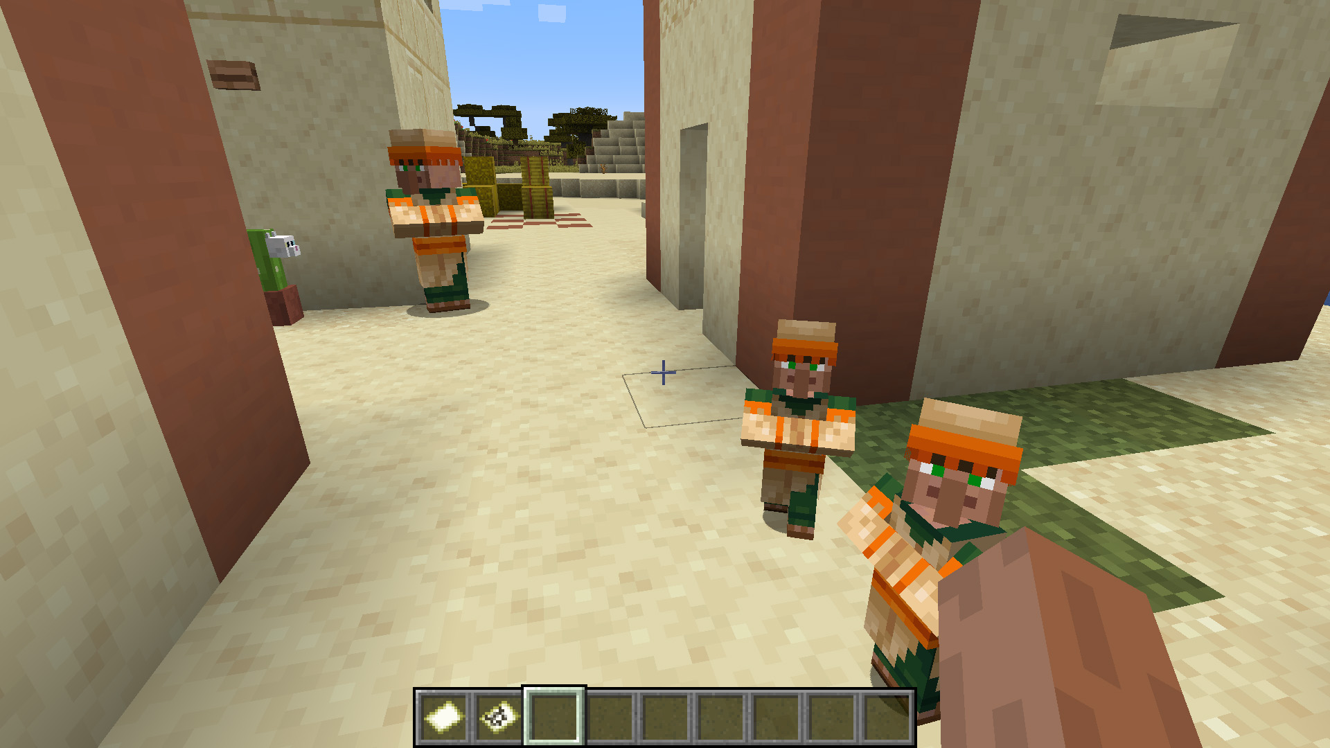 Minecraft breed villager - Two baby villagers stand outside a house in a desert village.