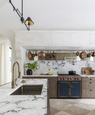 Rustic blue kitchen with hanging copper pots