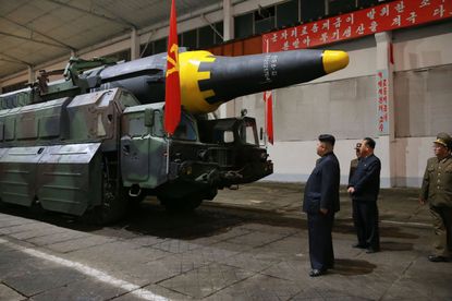 Kim Jong Un inspects a ballistic missile.