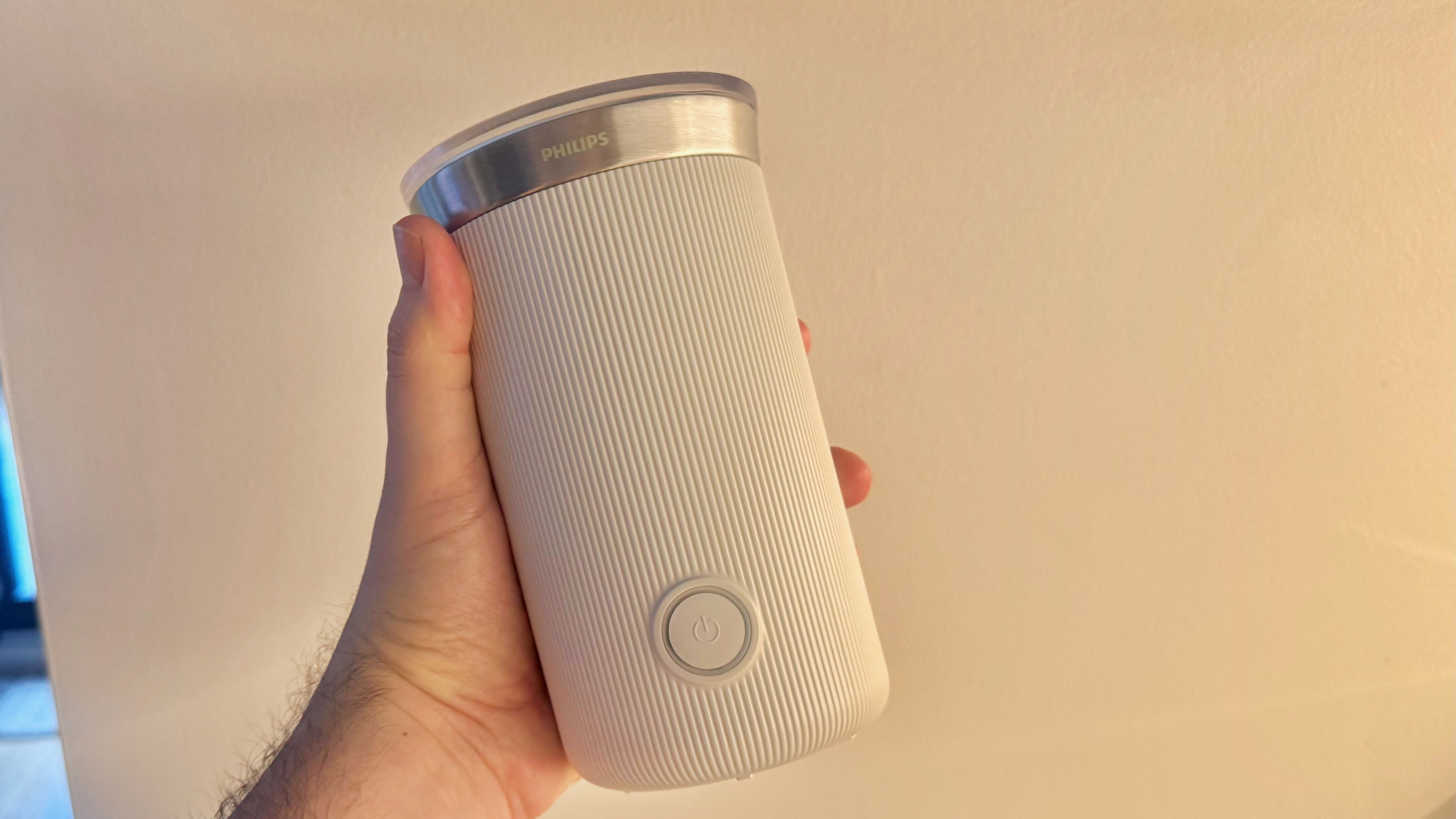 Philips Baristina Milk Frother held in a hand