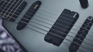 Close up on an EMG guitar pickup on a Peavey guitar