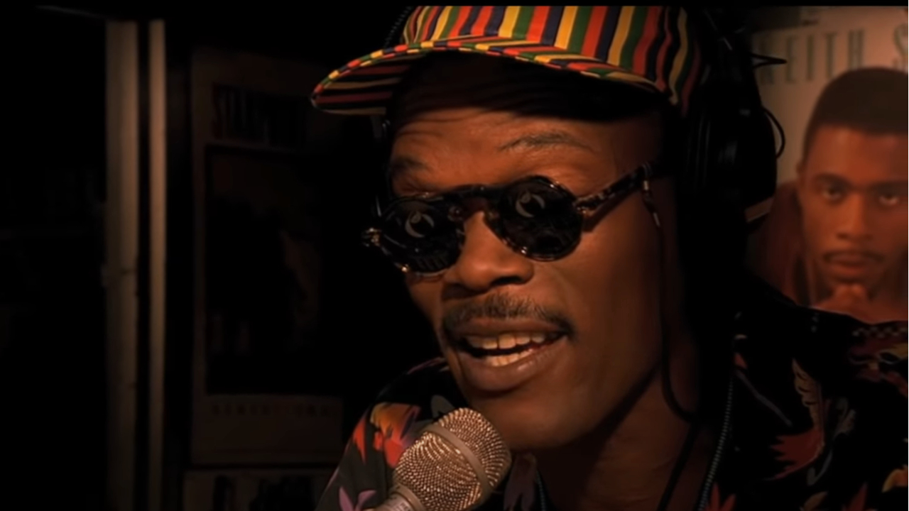 Samuel L Jackson speaking into a mic during a broadcast in Do The Right Thing.