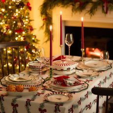 Primark Christmas cooware on a decorated table in front of a Christmas tree.