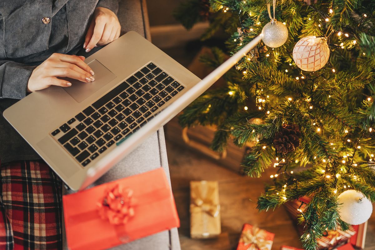 Close up of woman hands with, gifts, coffee cup and laptop