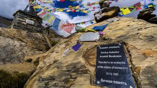 Many tibetan prayer flags are set up at a memorial for died