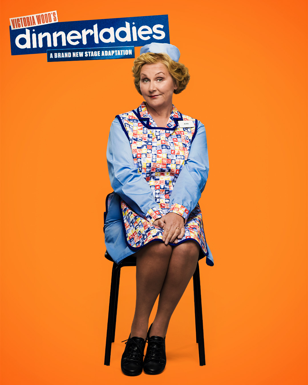 Sue Cleaver wearing a tabard in her role in dinnerladies