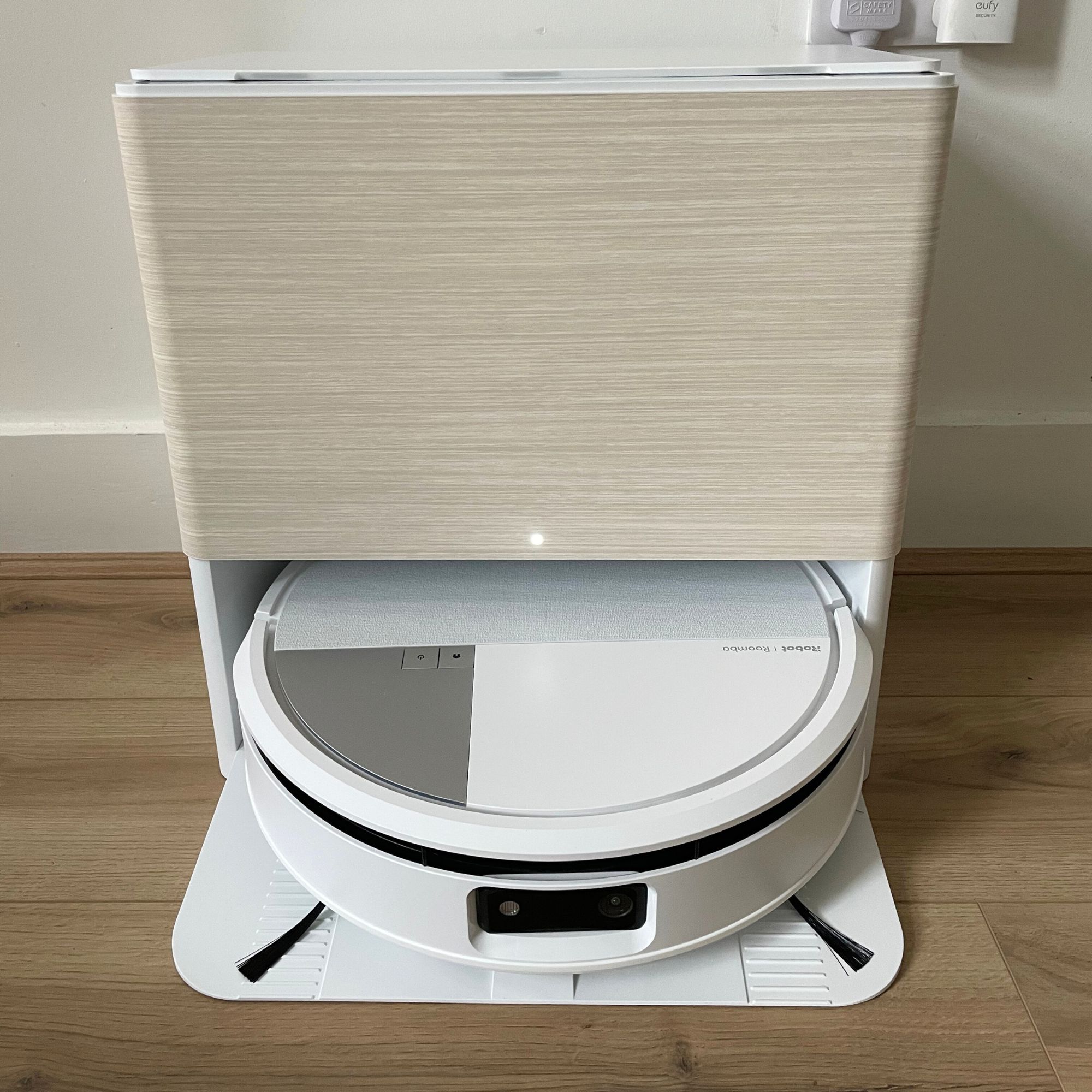 iRobot Roomba Max 705 Combo Robot Vacuum Cleaner and Mop sitting on wood-effect flooring