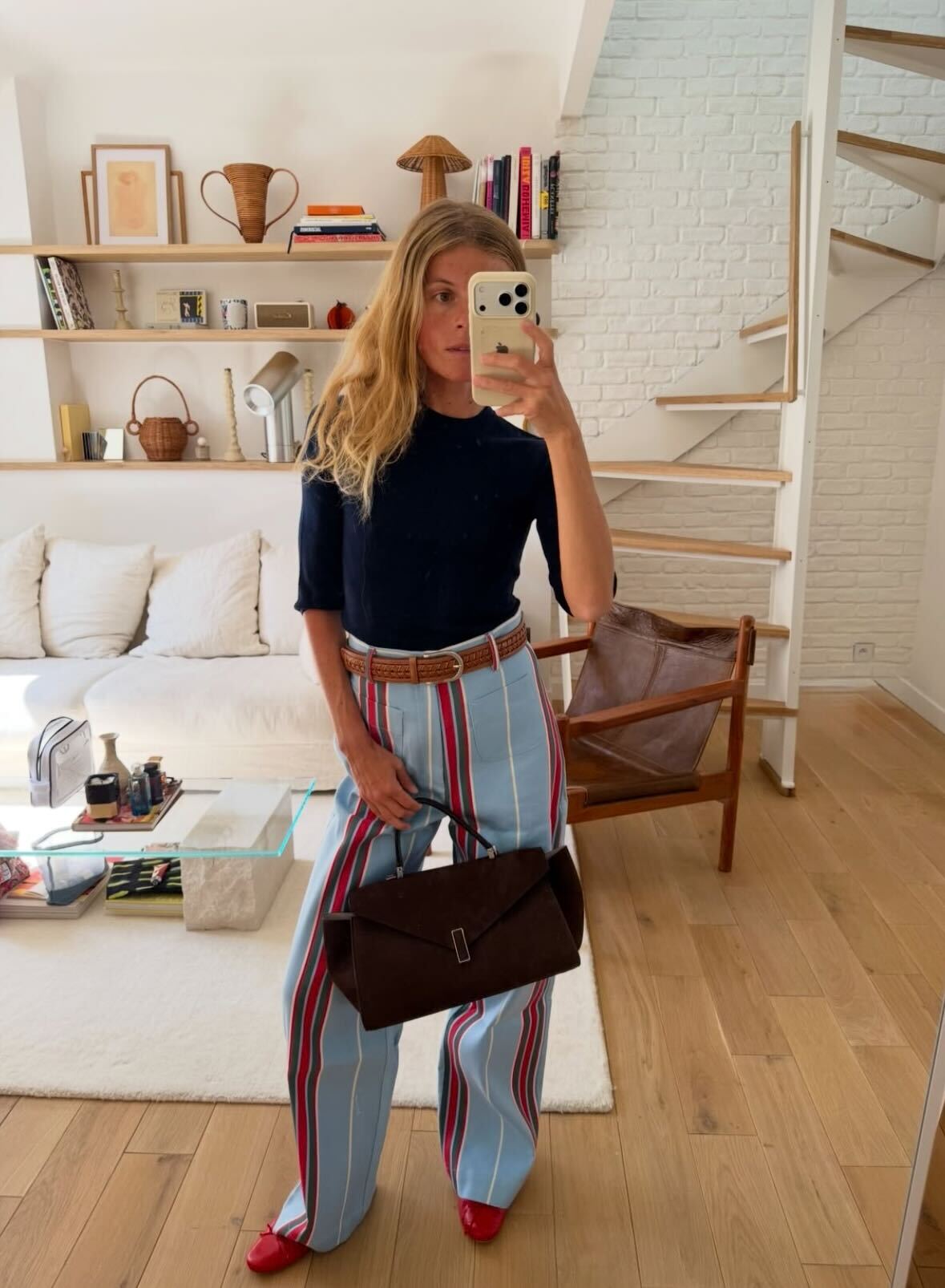 a woman wears striped pants with flats and a tee.