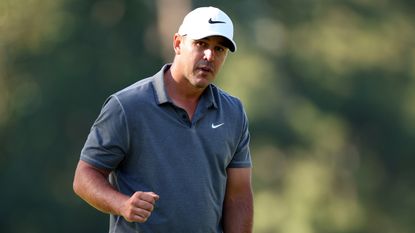 Brooks Koepka reacts after his par on the 10th during the fourth round of the 2023 Masters