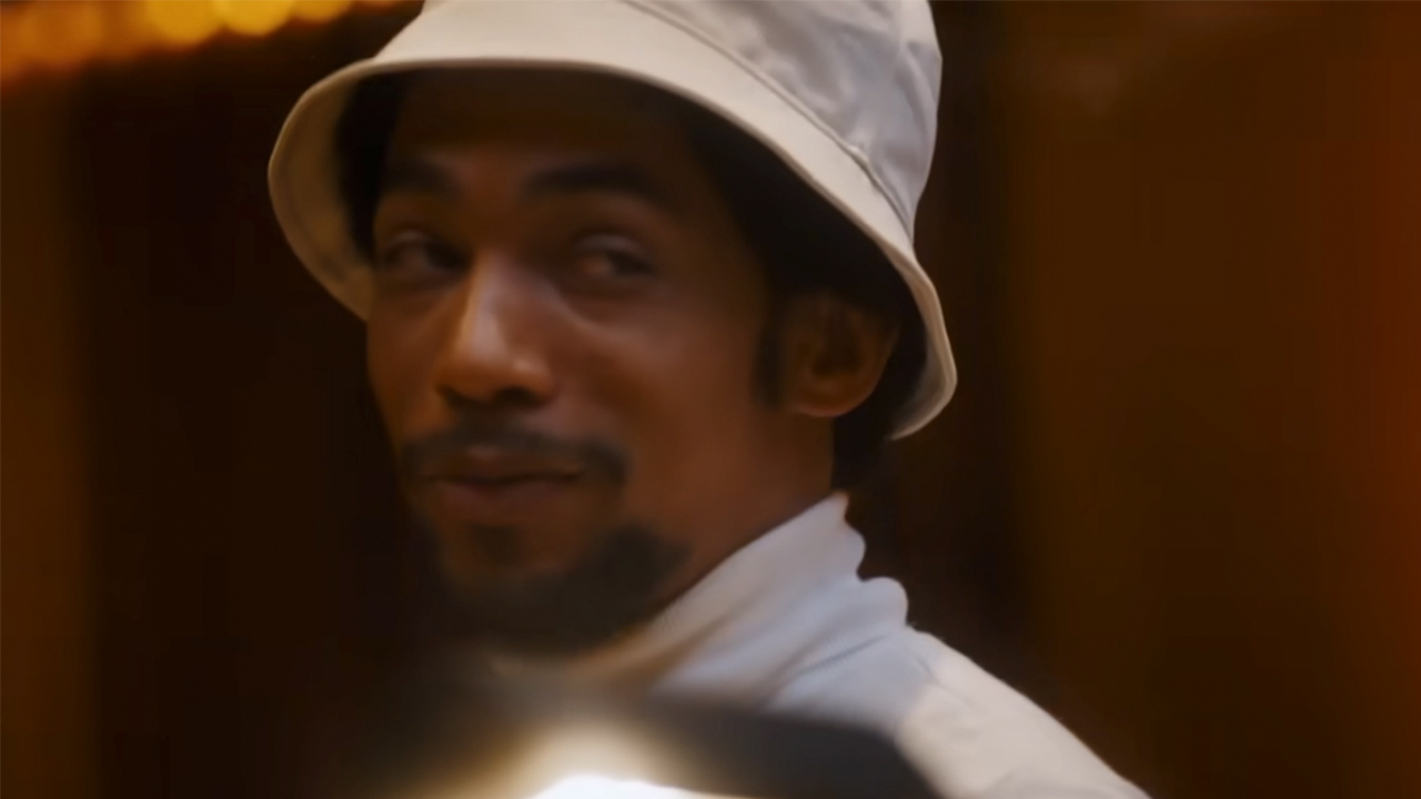 Kendrick Sampson in a bucket hat, as Quincy Jones in Michael