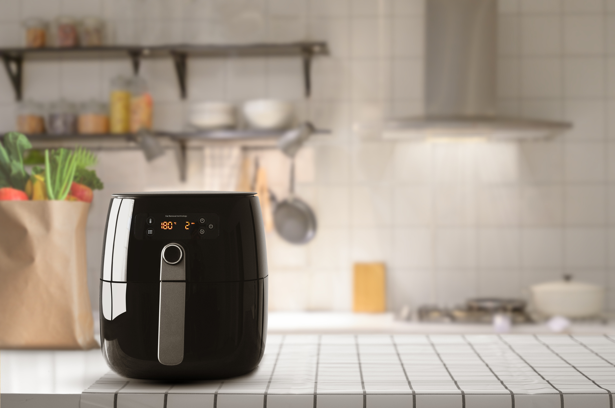 An air fryer sat on top of a kitchen worktop.
