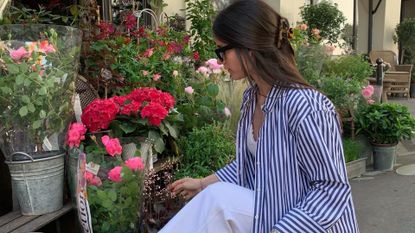 Photo of Julie @leasy_inparis picking flowers wearing striped shirt 
