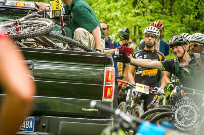 Riders get refreshments during the transfer stages of the Trans-Sylvania Epic enduro