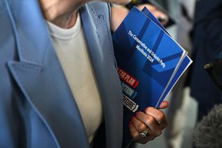 Health Secretary Victoria Atkins holds a copy of the Conservative manifesto (Photo by Leon Neal/Getty Images)