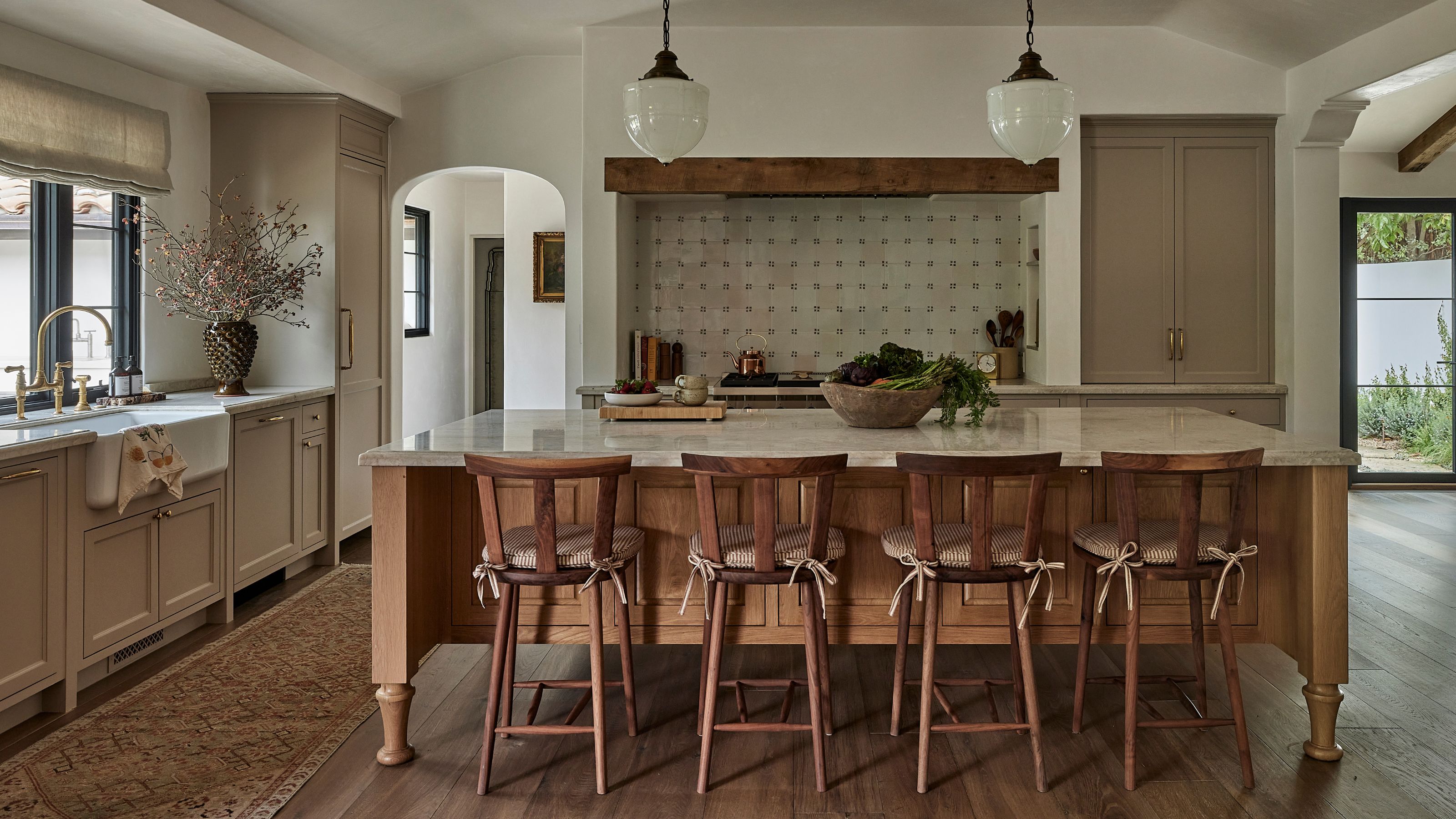 a tuscan style spanish revival kitchen with mixed wood tones and stone tiles