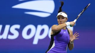 Jessica Pegula hits a forehand at the 2024 U.S. Open tennis, in a purple dress.