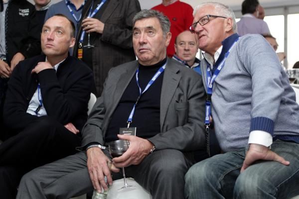 Wouter Vandenhoutte, Eddy Merckx and Patrick Lefevere watch the action on television