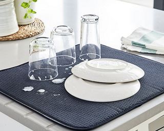 Lakeland Diamond Glass Drying Mat on counter with soapy glasses and two plates drying