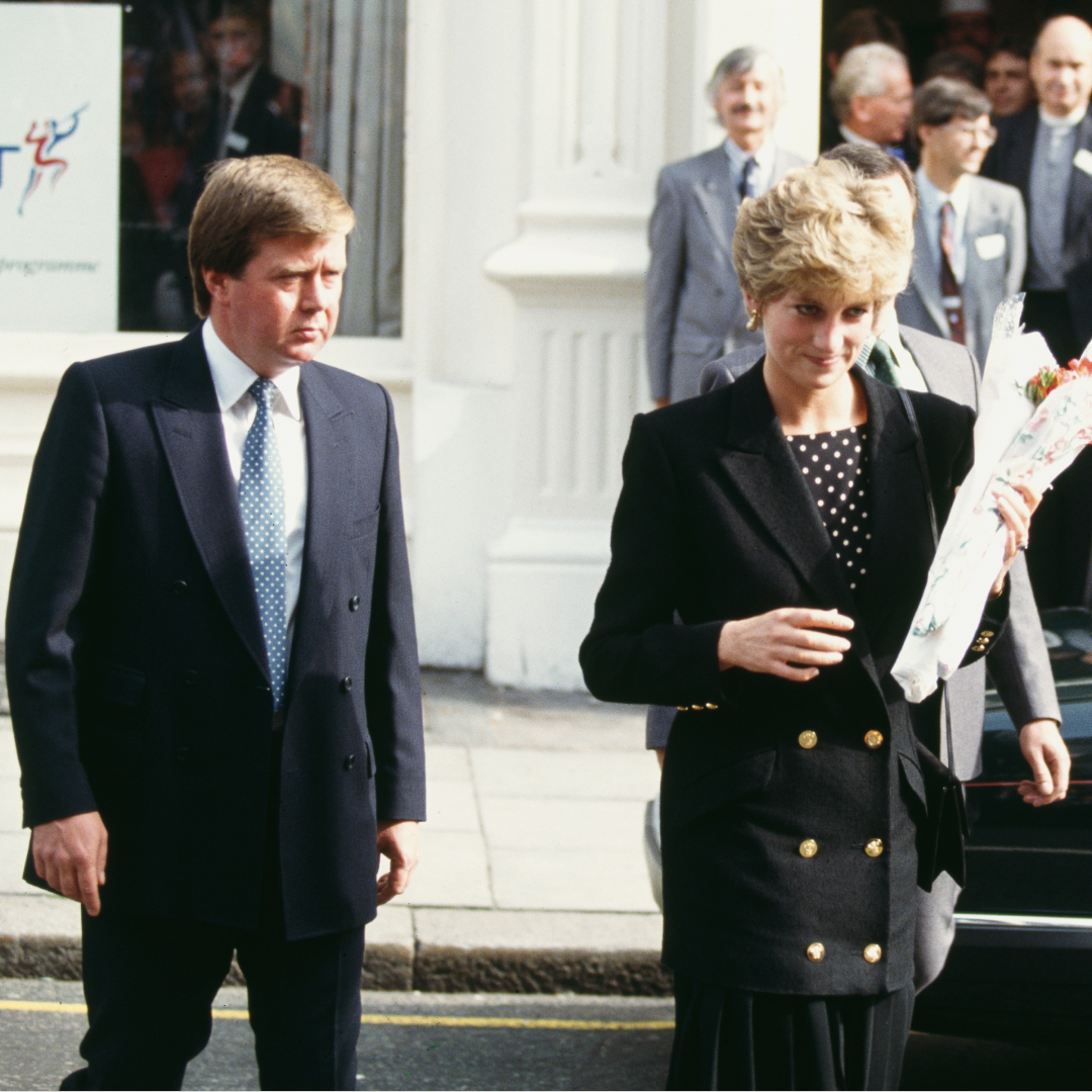 Princess Diana wearing a black blazer walking next to bodyguard Ken Wharfe