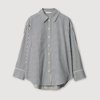 A cutout of a black and white oversized stripe shirt from &OtherStories on a white background