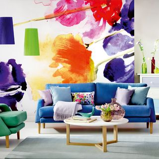 living room with wall mural and sofa