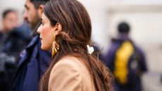 PARIS, FRANCE - FEBRUARY 29: A guest wears golden earrings, outside Elie Saab, during Paris Fashion Week - Womenswear Fall/Winter 2020/2021, on February 29, 2020 in Paris, France. (Photo by Edward Berthelot/Getty Images)