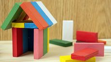 small house made out of multi-colored wooden blocks
