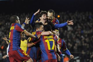 Lionel Messi celebrates with his Barcelona team-mates after scoring against Arsenal in the Champions League in 2011.