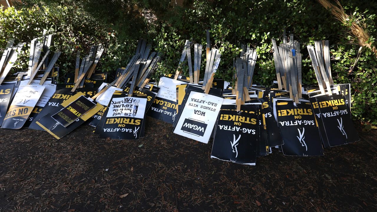 Protest signs are seen at the picket line outside Warner Bros. Studios on November 08, 2023 in Burbank, California