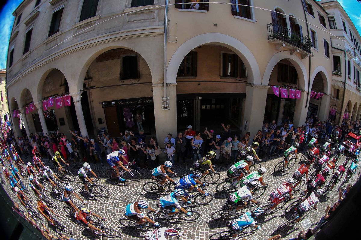 The peloton passes through a town