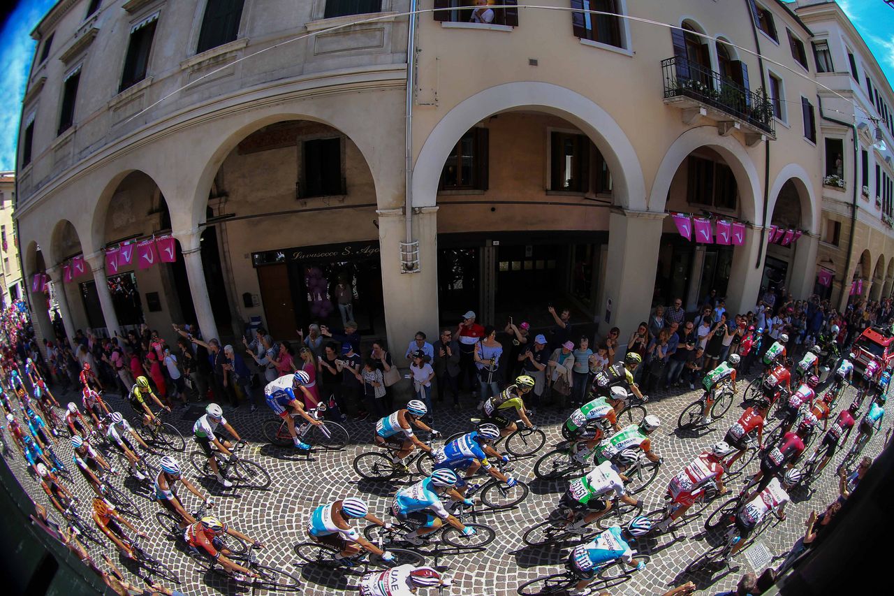 The peloton passes through a town