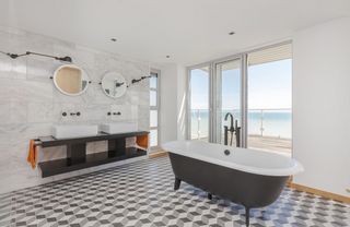 bathroom with bath tub and beach view