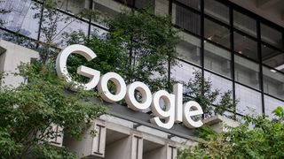 A photo of the Google Logo surrounded by plants at the company&#039;s NYC headquarters building