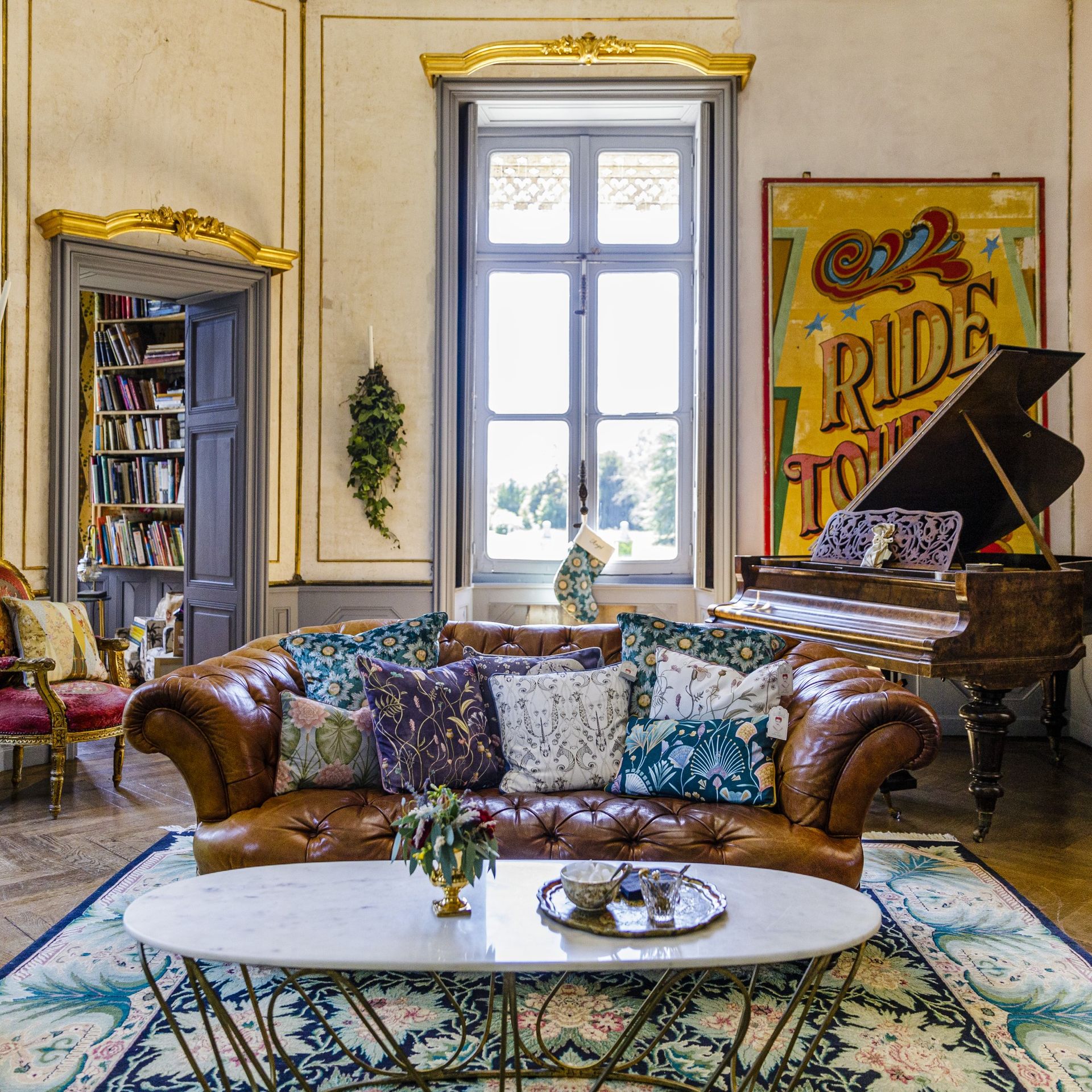 Brown leather sofa with cushions and piano
