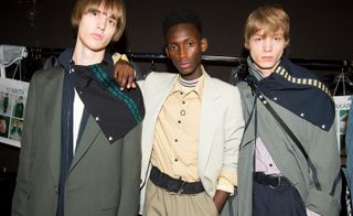 three male models at a fashion week wearing clothes designed by Lanvin