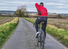 A cyclist suffering from back pain while riding