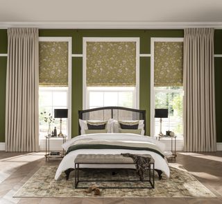 bedroom with double bed and windows dressed with neutral curtains and green patterned blinds