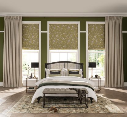 How to clean curtains – bedroom with double bed and windows dressed with neutral curtains and green patterned blinds