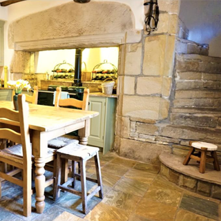 kitchen with stone arched recess and spiral stone staircase
