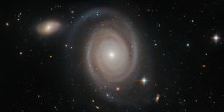 The spiral galaxy NGC 1706 may look a bit isolated drifting through the cosmos in this Hubble Space Telescope image, but this lonely galaxy has no shortage of neighbors. NGC 1706 belongs to a group of dozens of galaxies, all of which are held together by their mutual gravitational pull.