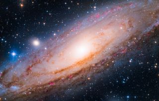 andromeda galaxy bathed in pink