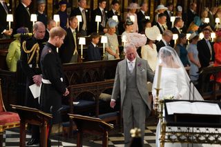 Meghan Markle independence - Prince Harry looks at his bride, Meghan Markle, as she arrives accompanied by Prince Charles, Prince of Wales during their wedding in St George's Chapel at Windsor Castle on May 19, 2018 in Windsor, England