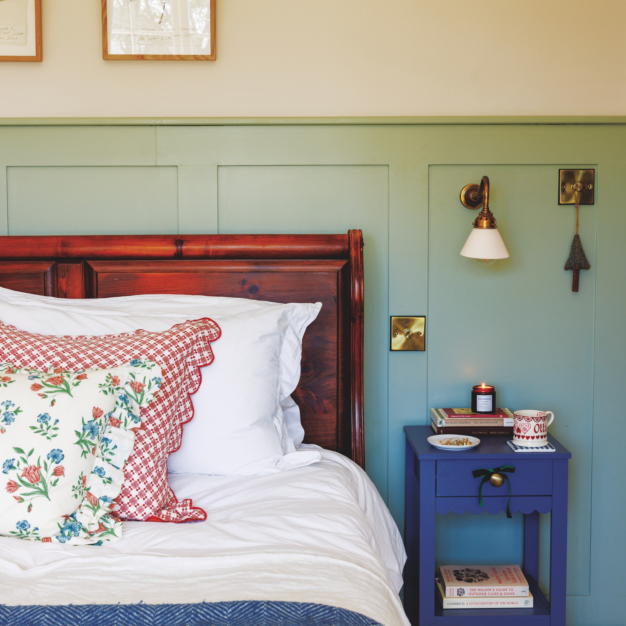 bedroom with wood half panel walls painted in green and antique style wooden bed